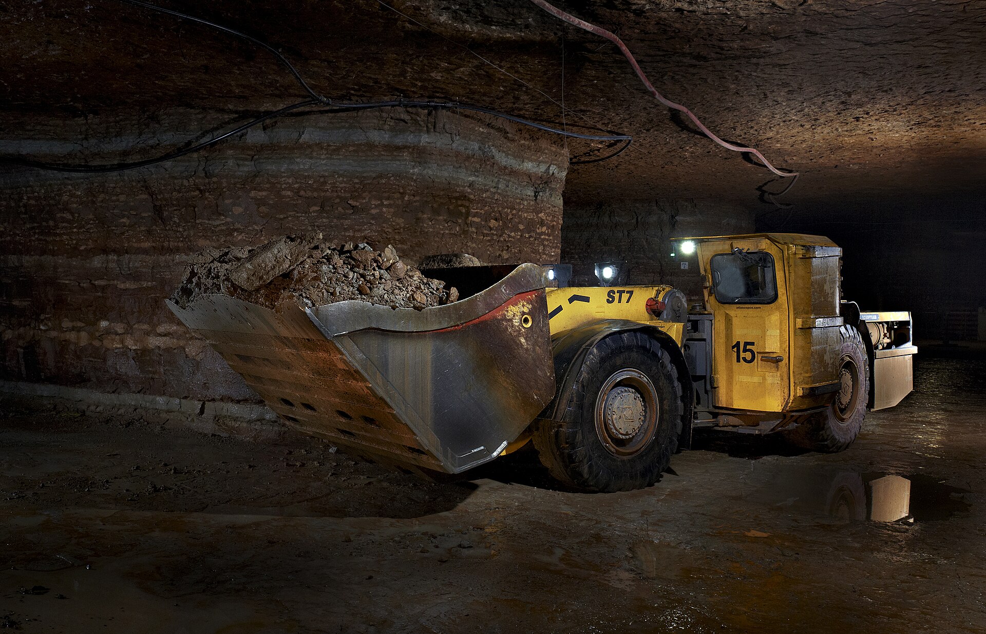 Underground load-haul-dump machine carrying broken rock